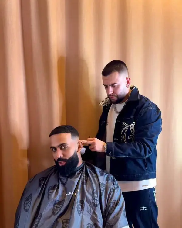 Xhris cortando el pelo a Eladio Carrión en su hotel durante el tour de España